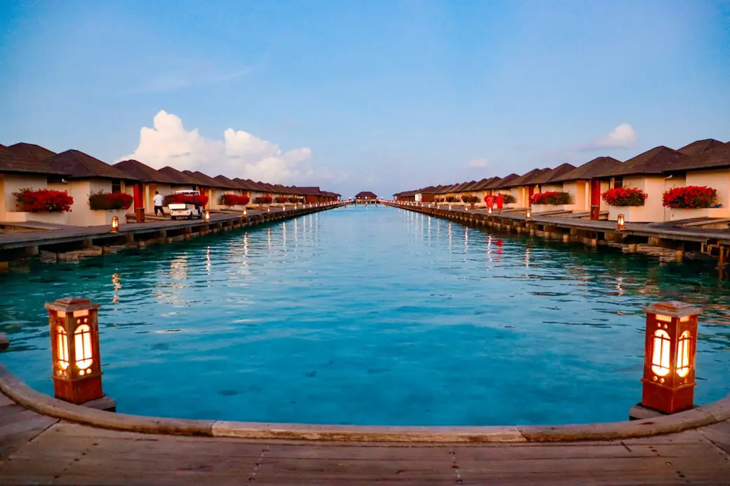 Overwater villas on a turquoise lagoon in the Indian Ocean